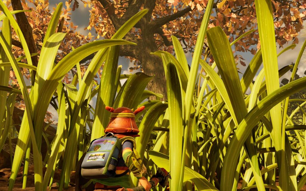 A player wearing an ant helmet looks up through the grass to a large oak tree